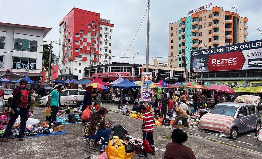 Vendors displaying second-hand trinkets, vintage collectibles, and antiques along the car-free street of Memory Lane Flea Market in Ipoh.