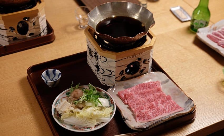 Traditional Japanese multi-course meal, regional sake, and hot spring preparation in snowy Aizu.